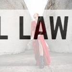 woman in red long sleeve dress and black boots standing beside gray concrete wall during daytime