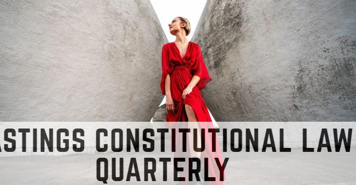 woman in red long sleeve dress and black boots standing beside gray concrete wall during daytime